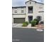 Charming two-story home with a two-car garage and landscaped bushes at 3900 E Baseline Rd # 166, Phoenix, AZ 85042