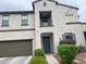 Inviting home exterior with blue door, balcony, neat landscaping, and a modern color palette at 3900 E Baseline Rd # 166, Phoenix, AZ 85042