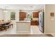 Spacious kitchen featuring stainless steel appliances, an island, and an adjacent dining area at 3900 E Baseline Rd # 166, Phoenix, AZ 85042
