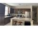 Well-equipped kitchen with dark cabinetry, stainless steel appliances, and an island at 3900 E Baseline Rd # 166, Phoenix, AZ 85042