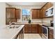 Well-maintained kitchen featuring stainless steel appliances, dark wood cabinets, and light countertops at 3900 E Baseline Rd # 166, Phoenix, AZ 85042