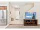 Open-concept living room with stainless steel appliances, carpet, and TV on display at 3900 E Baseline Rd # 166, Phoenix, AZ 85042