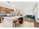 Open-concept kitchen and living room with a breakfast bar and comfortable seating area at 3900 E Baseline Rd # 166, Phoenix, AZ 85042