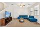 Bright living room with a comfortable blue sectional sofa and a modern metallic coffee table at 3900 E Baseline Rd # 166, Phoenix, AZ 85042