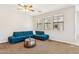 Well-lit living room with a large blue sectional sofa and natural light from the windows at 3900 E Baseline Rd # 166, Phoenix, AZ 85042