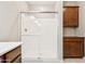 Modern bathroom features walk-in glass shower, tile flooring, and built in wooden storage at 3900 E Baseline Rd # 166, Phoenix, AZ 85042