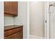 Bathroom features tiled flooring, wooden storage cabinet, and open doorway at 3900 E Baseline Rd # 166, Phoenix, AZ 85042