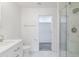 Updated bathroom features a frameless glass shower and modern fixtures with view to walk in closet at 4116 W Marshall Ave, Phoenix, AZ 85019