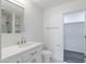 Modern bathroom boasts a sleek vanity, brushed nickel fixtures, and contemporary tile work at 4116 W Marshall Ave, Phoenix, AZ 85019