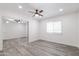 Bright bedroom features ceiling fan, gray wood flooring, and closet with mirrored sliding doors at 4116 W Marshall Ave, Phoenix, AZ 85019
