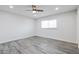 Bright bedroom features a ceiling fan, recessed lighting, window, and light gray flooring at 4116 W Marshall Ave, Phoenix, AZ 85019