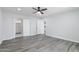 Bright bedroom features gray wood flooring and natural light, with closet access at 4116 W Marshall Ave, Phoenix, AZ 85019