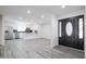 Bright entryway leading to a kitchen with stainless steel appliances and gray flooring at 4116 W Marshall Ave, Phoenix, AZ 85019