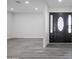 Elegant entryway with modern gray floors and a stunning front door at 4116 W Marshall Ave, Phoenix, AZ 85019