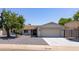 Inviting single-story house with a well-kept front yard, concrete driveway, and garage at 4116 W Marshall Ave, Phoenix, AZ 85019