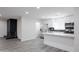 Bright kitchen featuring stainless steel appliances, black brick backsplash, and white cabinetry at 4116 W Marshall Ave, Phoenix, AZ 85019