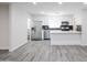 Modern kitchen with stainless steel appliances, white cabinets, and stylish backsplash at 4116 W Marshall Ave, Phoenix, AZ 85019