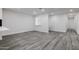 Bright living room featuring modern gray wood floors and minimalist design, perfect for contemporary living at 4116 W Marshall Ave, Phoenix, AZ 85019