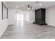 Bright living room featuring modern gray floors, fireplace, and access to the backyard at 4116 W Marshall Ave, Phoenix, AZ 85019