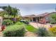 Beautifully landscaped backyard featuring a patio, hot tub, and a colorful array of desert plants at 41162 W Hayden Dr, Maricopa, AZ 85138