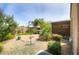 Landscaped backyard featuring a patio, hot tub, lush plants, and gravel at 41162 W Hayden Dr, Maricopa, AZ 85138