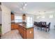 Open floor plan kitchen with stainless steel appliances, an island, and tile flooring at 41162 W Hayden Dr, Maricopa, AZ 85138