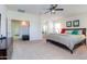 Spacious main bedroom with a ceiling fan, ensuite bathroom, and walk-in closet access at 41162 W Hayden Dr, Maricopa, AZ 85138