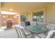 Covered patio with a dining table set, barbecue, and sliding glass door at 41162 W Hayden Dr, Maricopa, AZ 85138