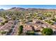 Scenic aerial shot of a neighborhood, showcasing well-maintained homes, pools, and mountain views at 4215 W Hackamore Dr, Phoenix, AZ 85083