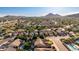 Wide aerial view showcasing the community, mountains, and some homes with swimming pools at 4215 W Hackamore Dr, Phoenix, AZ 85083