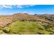 A sprawling, green athletic field is ideal for outdoor activities with mountain views and mature trees at 4215 W Hackamore Dr, Phoenix, AZ 85083