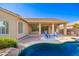 The backyard boasts a pool with patio, covered patio with outdoor kitchen, and manicured landscaping at 4215 W Hackamore Dr, Phoenix, AZ 85083