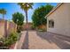 The backyard is landscaped with gravel areas, grassy areas, mature shade trees, and plants and flowers at 4215 W Hackamore Dr, Phoenix, AZ 85083