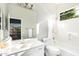 Bright bathroom featuring a shower-over-tub, toilet, vanity, mirror and window at 4215 W Hackamore Dr, Phoenix, AZ 85083