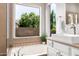 Bathroom featuring a tub with a window view and a vanity with granite-look countertops at 4215 W Hackamore Dr, Phoenix, AZ 85083