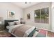 Cozy bedroom featuring a large window, comfortable bed, and neutral color scheme at 4215 W Hackamore Dr, Phoenix, AZ 85083