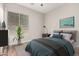 Comfortable bedroom featuring a large window, stylish decor, and accent wall at 4215 W Hackamore Dr, Phoenix, AZ 85083