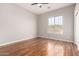 Bedroom features hardwood flooring, large window and ceiling fan at 4215 W Hackamore Dr, Phoenix, AZ 85083