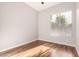 Bright bedroom featuring modern blinds, wood-look floors, and neutral walls at 4215 W Hackamore Dr, Phoenix, AZ 85083