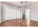 Bedroom with hardwood floors, neutral paint, and sliding closet doors at 4215 W Hackamore Dr, Phoenix, AZ 85083