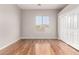 Empty room featuring hardwood floors, window with blinds and sliding doors at 4215 W Hackamore Dr, Phoenix, AZ 85083
