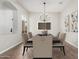 Tastefully decorated dining room with elegant chandelier, seating for six, and natural light at 4215 W Hackamore Dr, Phoenix, AZ 85083