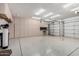 Spacious garage featuring ample built-in storage cabinets and a workbench for projects at 4215 W Hackamore Dr, Phoenix, AZ 85083