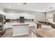 Spacious kitchen featuring ample counter space, white cabinetry, and modern appliances at 4215 W Hackamore Dr, Phoenix, AZ 85083