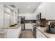 Bright kitchen featuring white cabinets, stainless steel appliances, and tile backsplash at 4215 W Hackamore Dr, Phoenix, AZ 85083