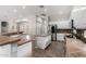 Bright kitchen featuring white cabinetry, stainless steel appliances and a center island with stone countertops at 4215 W Hackamore Dr, Phoenix, AZ 85083
