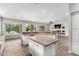 Open kitchen with central island connects to the living room with backyard view in the background at 4215 W Hackamore Dr, Phoenix, AZ 85083