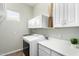 Bright laundry room with white cabinetry, countertop, washer, and dryer at 4215 W Hackamore Dr, Phoenix, AZ 85083