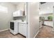 Laundry room with white cabinetry, counter space, washer, dryer and tile floors at 4215 W Hackamore Dr, Phoenix, AZ 85083
