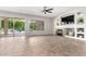 Bright living room with a fireplace, built-in shelves, and access to the backyard patio at 4215 W Hackamore Dr, Phoenix, AZ 85083